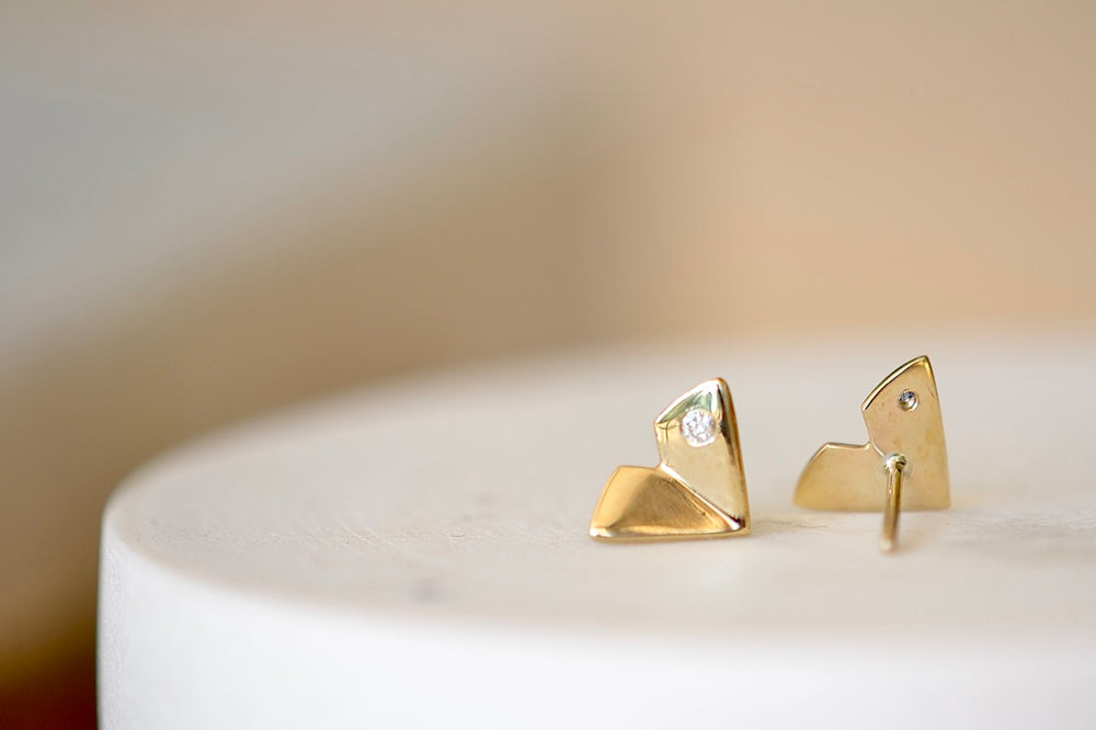 
            
                Load image into Gallery viewer, Large Origamin Stus with diamonds by Kaylin Hertel are Perfectly minimal gold origami bird studs in 14k yellow gold with one diamond each.
            
        