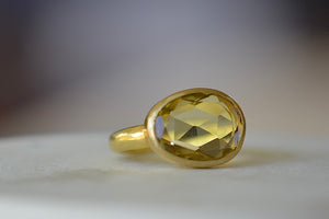 Lemon Quartz Large Greek Ring designed by Pippa Small is an organically shaped light yellow, faceted and transparent lemon quartz set in 18k yellow gold. Slightly tilted.. 