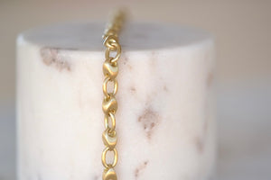 Marian Maurer Pebble Chain Bracelet is a smooth link bracelet in 18k recycled yellow gold with satin finish and in 18k yellow gold with satin finish with hook and eye closure with a safety.