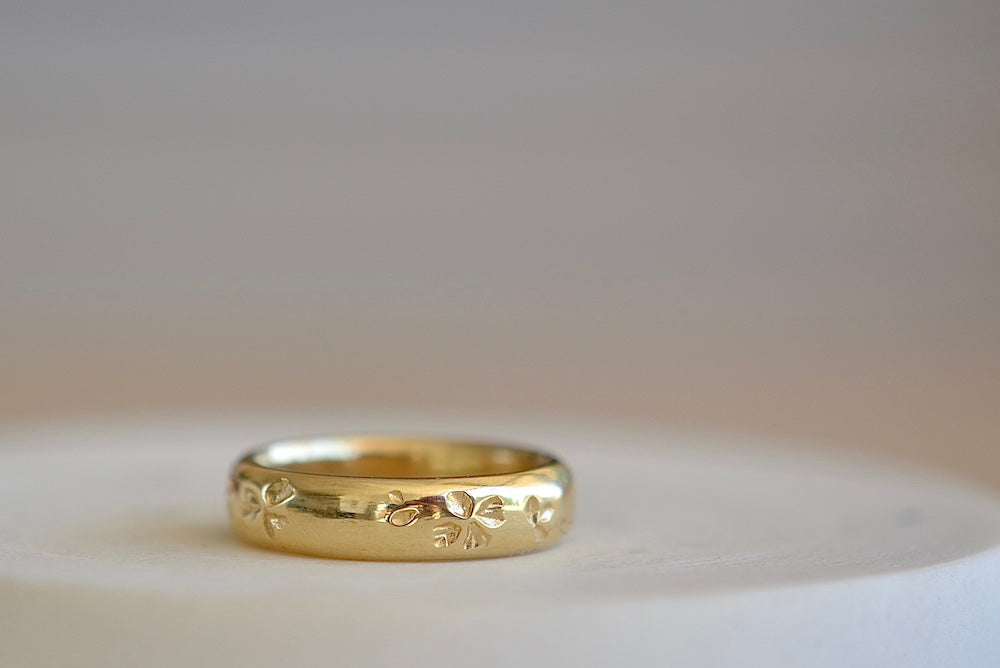 Kaylin Hertel Striped Petal Print Band in Blue is a thick comfort fit band encircled by hand carved petal print and adorned with 3 pave stripes in diamond and dark blue sapphires, white and black diamonds.. 