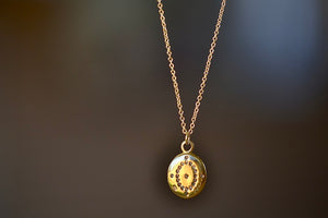 
            
                Load image into Gallery viewer, Day Dream Pendant Necklace is a A small round 18k yellow gold disc with one centered white diamond, a circle of diamonds around it and four more on the edge make a starburst pattern and pendant on an 18k yellow gold chain designed in NY by Adel Chefridi.. 
            
        