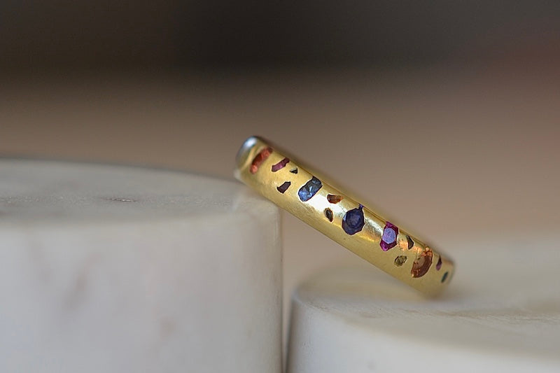 Rainbow Confetti Ring Size 7.5 by Polly Wales  is a narrow 18k gold band with speckled mixed sapphires around the circumference for a beautiful confetti-like appearance. Recycled gold. Cast not set. Handcrafted in Los Angeles.