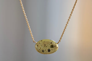 Elysian Necklace by Polly Wales is An oval disc in 18K yellow gold with scattered confetti style rainbow sapphires in yellow, green and black on a beautiful 18k yellow gold chain 18".  Recycled gold. Cast in Place. Cast not set. Handmade in Los Angeles.