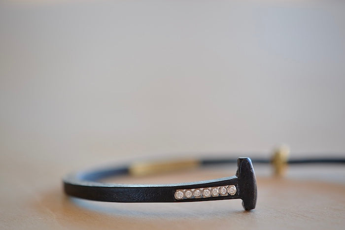 
            
                Load image into Gallery viewer, Pat Flynn Short Stripe Seven (7) Stone Bracelet is a Forged and tapered nail bracelet in blackened iron with seven accent diamonds on one side and completed with an 18k gold hinge and ball catch closure. Handcrafted in New York.
            
        