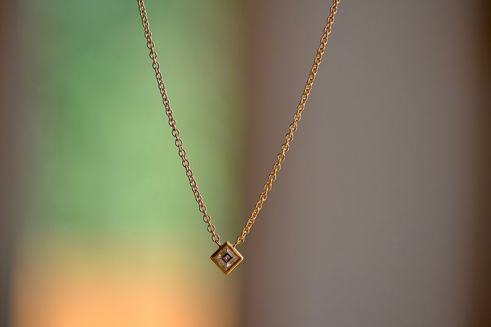 Carre Cut Diamond Bezel Solitaire Necklace by Lizzie Mandler is a A beautiful carre cut and bezel set diamond pendant on a classic adjustable cable chain in 18k yellow gold.