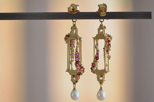 Polly Wales Jade Terrace Pagoda Earrings 18K yellow recycled gold pagoda forms hanging from a bird stud encrusted with a pearl pink and orange sapphire sapphires. Cast not set.