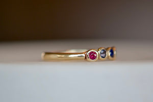 
            
                Load image into Gallery viewer, Close up on organic narrow band and Ruby on 14k gold Rise ring by Makiko Wakita.
            
        