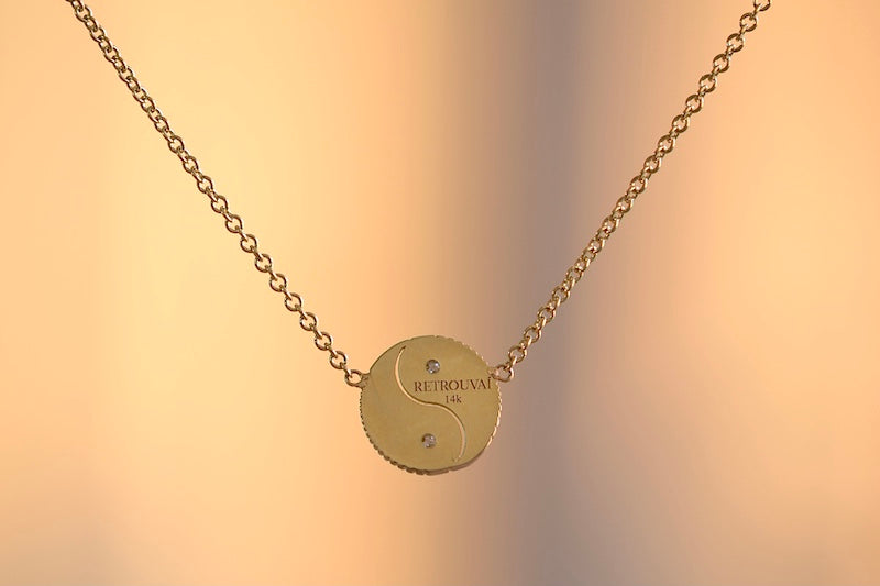 
            
                Load image into Gallery viewer, Retrouvai Mini All Gold Yin Yang Pendant with Diamonds  A unique modern take on an heirloom pendant. A beautifully textured and shaped gold disc accented with two (2) white diamonds hangs on a 16&amp;quot; 14k yellow gold chain.
            
        