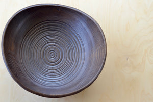 
            
                Load image into Gallery viewer, Birds eye view of Circle Factory Brown Bowl in Black Oak with ridged detail. Made and designed by George Peterson. 
            
        