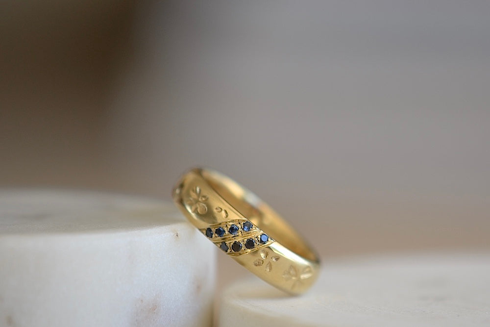 
            
                Load image into Gallery viewer, Kaylin Hertel Striped Petal Print Band in Blue is a thick comfort fit band encircled by hand carved petal print and adorned with 3 pave stripes in diamond and dark blue sapphires, white and black diamonds.. 
            
        
