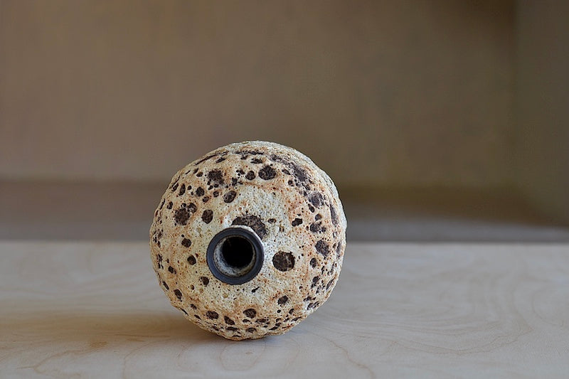 
            
                Load image into Gallery viewer, The Bottle Shaped Vase in Cream to Orange Volcanic Glaze is a hand thrown stoneware vase with volcanic glaze in cream by Heather Rosenman.
            
        