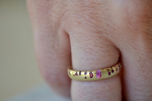 Pink Sapphire Confetti Band Ring by Polly Wales in size 6 shown on ring finger. Cast not set. 