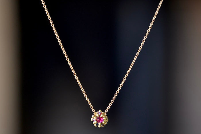 
            
                Load image into Gallery viewer, Polly Wales Small Sputnik Dome Pendant Necklace is a domed half sphere in 18k yellow gold with encrusted and inverted pink, blue and yellow sapphires around the circumference hangs on a beautiful chain. Cast Not Set. Recycled Gold.
            
        