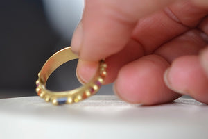 Detail of the the gold band on the Wide Harlequin Nina Pinch Ring designed by Polly Wales.