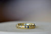 The Cornflower Blue Sapphire Confetti Band designed by Polly Wales is a narrow 18k yellow recycled gold wedding band/ring with speckled ombre light blue sapphires around the circumference. It is cast not set and handmade in Los Angeles.
