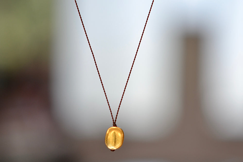 
            
                Load image into Gallery viewer, Margaret Solow 18k Gold Pendant Necklace Round Seed Bean Nylon Cord
            
        