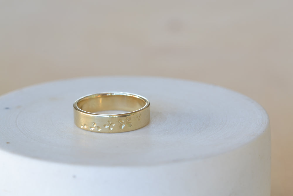 
            
                Load image into Gallery viewer, Cascade Petal Print Flat wedding band by Kaylin Hertel in 14k yellow gold.
            
        