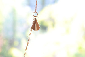 Chime Necklace by Kaylin Hertel in 14k yellow gold or sterling silver are made out of three chimes on a chain with signature clasp.