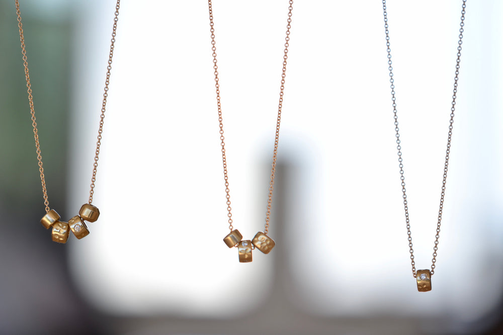 One bead, three bead, and four bead necklace in 14k gold with Canadian diamonds by Kaylin Hertel.