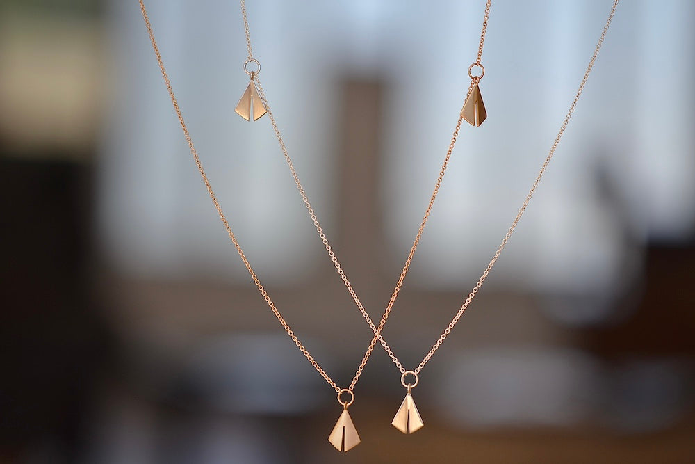 Chime Necklace by Kaylin Hertel in 14k yellow gold or sterling silver are made out of three chimes on a chain with signature clasp.