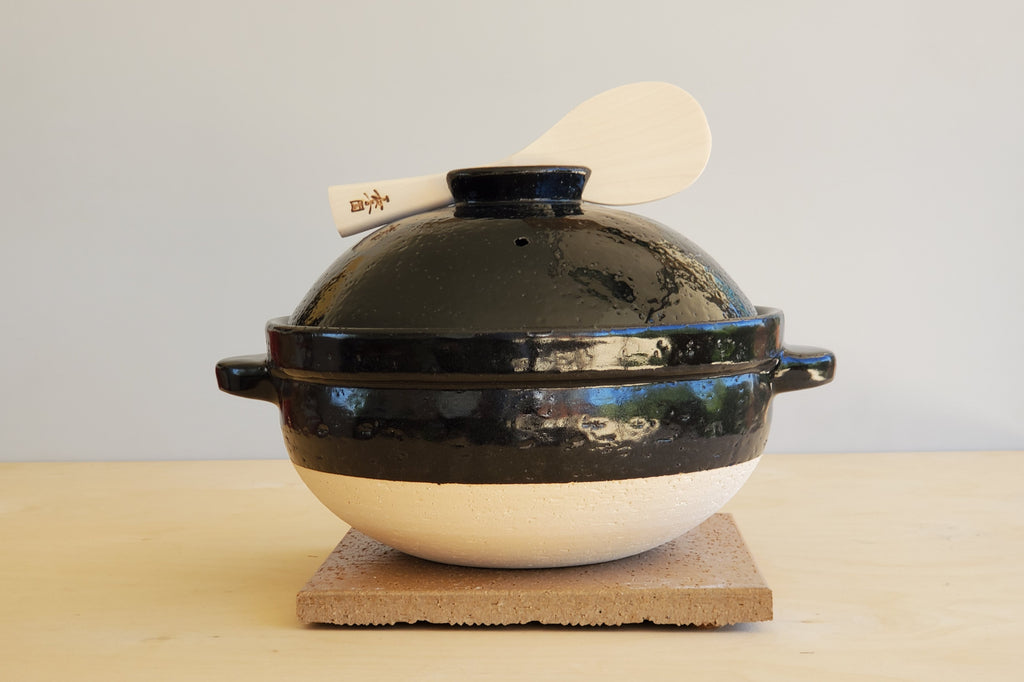 Donabe with rice spoon.