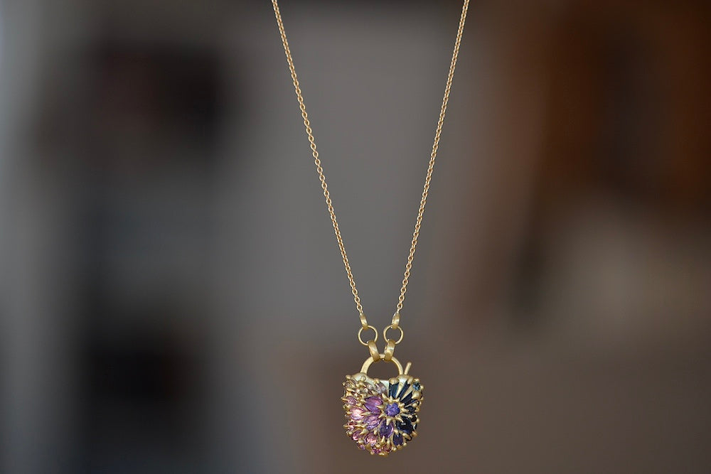 Medium Serpentine Padlock Necklace by Polly Wales Coeur de Fantasie in 18k yellow gold with white diamonds and pink, blue, lilac and purple sapphires encrusted on 20" chain. Cast not Set. 