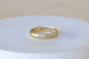 
            
                Load image into Gallery viewer, Slim Petal Print band in 14k yellow gold by Kaylin Hertel.
            
        