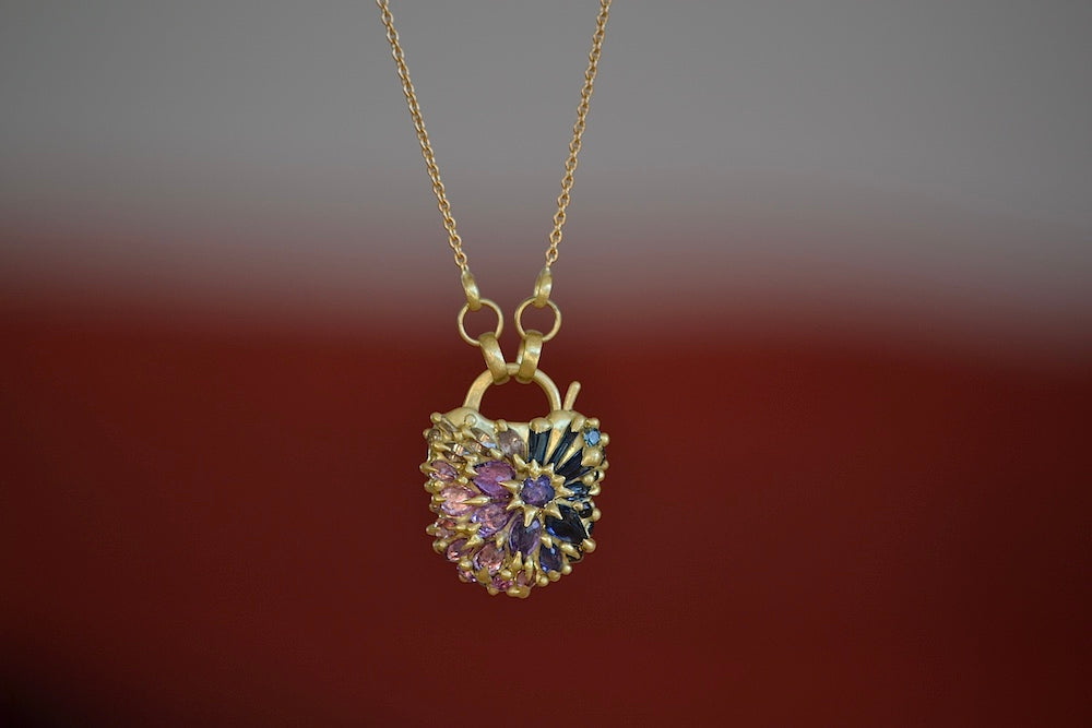 
            
                Load image into Gallery viewer, Medium Serpentine Padlock Necklace by Polly Wales Coeur de Fantasie in 18k yellow gold with white diamonds and pink, blue, lilac and purple sapphires encrusted on 20&amp;quot; chain. Cast not Set.
            
        