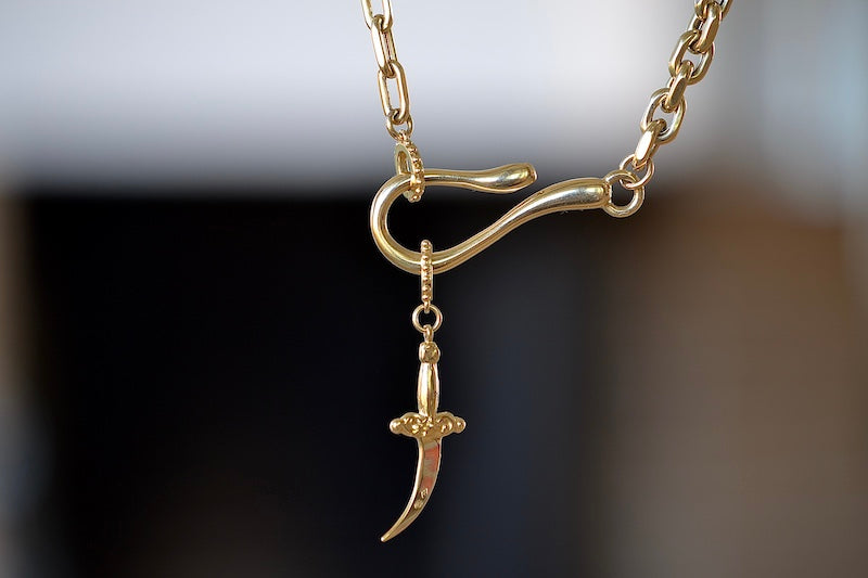 Meredith Kahn dagger Charm with loop ring in brass on a hook and loop cable chain necklace..