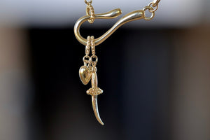 Meredith Kahn Heart and dagger Charm with loop ring in brass on a hook and loop cable chain necklace..