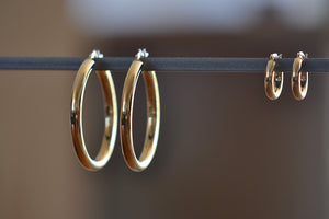 Large and Small Hollow Hoop Earrings by OK in 14k yellow gold with click closure. Tube is 3 or 4mm thick and full diameter is 38mm or 19mm. 