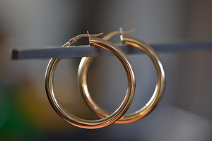 
            
                Load image into Gallery viewer, Large Hollow Hoop Earrings by OK in 14k yellow gold with click closure. Tube is 3 or 4mm thick and full diameter is 38mm or 19mm. 
            
        